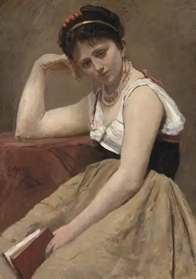 A pensive faced woman sits, slightly hunched, holding a book.