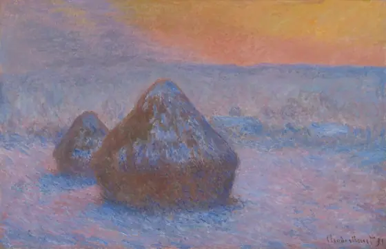 Two haystacks, dusted with snow, in a hazy, snow-covered field at sunset. The snow is highlighted in purple tones, the sky a yellow and orange gradient.