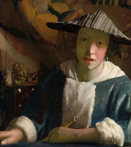Shown from the waist up, a young woman sits on the other side of the edge of a table, leaning toward us on one elbow in this vertical painting. She looks at us with dark brown eyes under faint, arched brows.