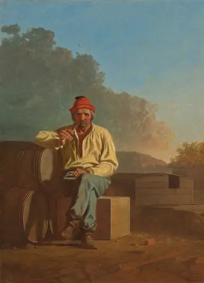 A bearded man with wrinkled, peachy skin and reddened cheeks sits and smokes a pipe on a wooden box in a landscape in this vertical painting. The man’s body faces us, and he peers at us with dark eyes under heavy, bushy white brows.