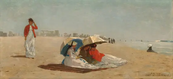 Four women with pale, peach skin, wearing long white dresses, stand or sit on a sunny beach in this wide, horizontal painting. People and carriages are painted as hazy gray silhouettes spread along the beach in the distance.