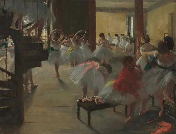 A dimly lit ballet studio is filled with about two dozen young dancers tying on their shoes, stretching, or practicing en pointe in this horizontal painting.