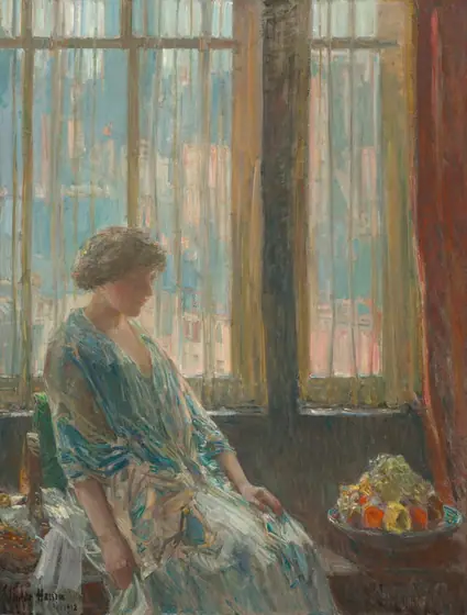 Shown from the knees up, a woman wearing an ice- and teal-blue dress and shawl sits in front of a window in this vertical painting. The scene is painted loosely with brushstrokes especially evident in the clothing and background.