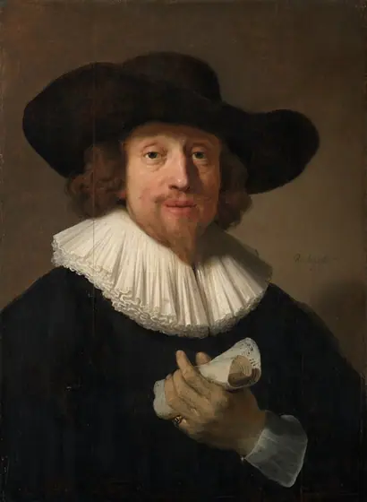 Shown from the waist up, a bearded man with pale, peachy skin, wearing a black wide-brimmed hat and jacket, and a broad, layered, white collar, holds up a piece of rolled up paper in this vertical portrait painting.