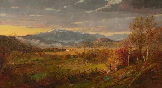 This painting shows a landscape with tall, blue, snow-capped mountains in the distance. There are blue and purple clouds in the yellow sky.