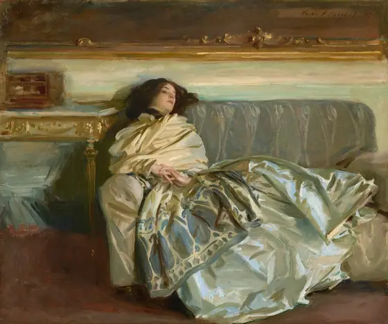 A woman with pale skin and dark brown hair is swathed in silky fabric as she reclines along a gray couch in this horizontal painting. Her head rests along the backrest of the sofa to our left, so her body extends to our right.