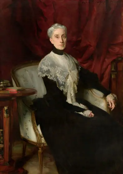 A woman with pale skin, wearing a sheer, lace shawl over a high-necked, ink-black dress sits in an upholstered chair in front of a dark, cranberry-red curtain in this vertical portrait painting.