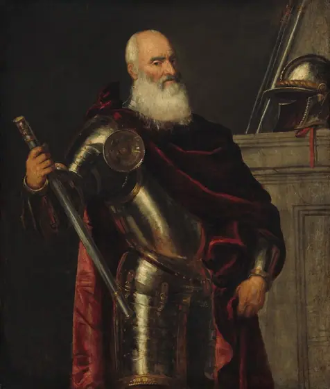 Shown from the thighs up, an older, balding man with a long white beard stands wearing a full suit of armor draped in a burgundy-red cloak in this vertical portrait painting.