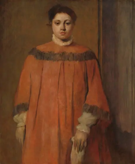 Shown from the knees up, a pale-skinned woman in a voluminous rust-orange dress stands facing us in this vertical portrait painting. She looks toward us but slightly down with dark brown eyes under curved brows.