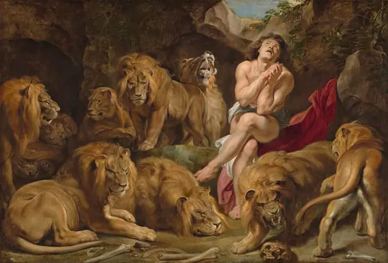A nearly nude, muscular man with pale, peachy skin sits in an underground cave among seven male and two female lions in this horizontal painting.