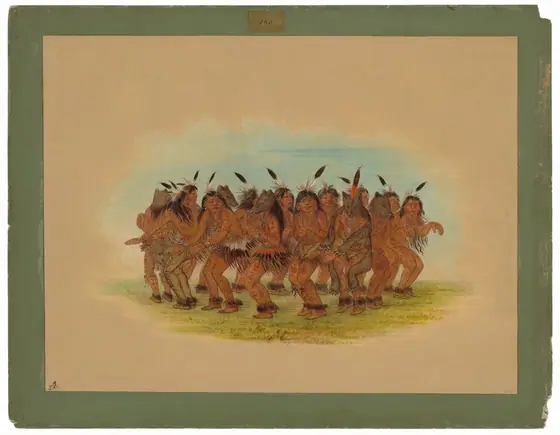 The image shows a group of Native American men gathered closely together in a dance formation. They are positioned facing slightly towards the right, with their full bodies visible.