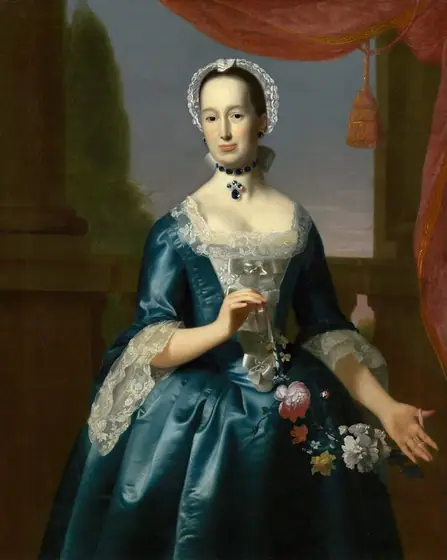 Shown from the knees up, a woman wearing a shimmering teal-blue gown and holding a garland of flowers stands in front of columns and a landscape in this vertical portrait painting.