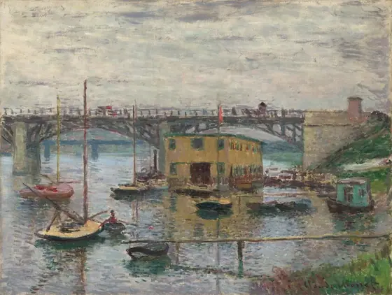 We look across a glimmering river toward docks, about a dozen small boats, and a mustard-brown, boxy building under a bridge that crosses the width of the canvas in this horizontal landscape painting.