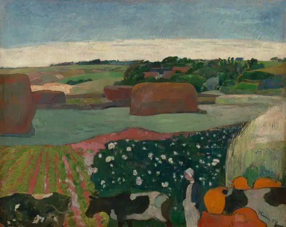 We look out onto a landscape with tawny-brown haystacks and trees among a patchwork of moss, lime, mint, and pine-green fields in this stylized, horizontal painting. The scene is painted with mostly flat areas of color.