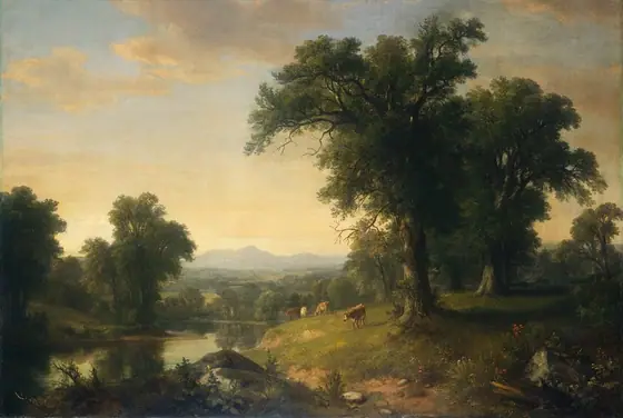 A placid river winds past low hills with cows to fields blanketed with trees leading back to mountains lining the horizon in this hazy, horizontal, landscape painting.