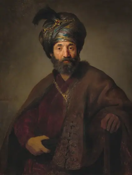 Shown from the waist up, a bearded man with a tanned, peachy complexion wears a turban and voluminous robes and looks out at us in this vertical portrait painting.