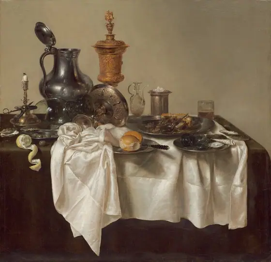 A jumble of pewter plates and a pitcher, glass goblets, a gold chalice, a brass candlestick, and other vessels along with lemons, olives, and the remains of a mince pie are arranged on a cream-white tablecloth bunched on a dark green…