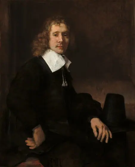 Shown from the hips up, a young man with pale skin and wearing black clothing sits with his body angled to our right as he turns to look at us in this vertical portrait painting. He looks out with green eyes under hooded lids.