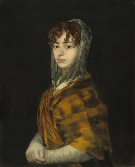 Shown from the waist up in front of a black background, a young woman with pale white skin and curly brown hair looks directly out at us over her shoulder with her body angled to our left in this vertical portrait.